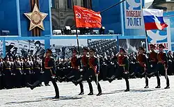 Honour guard marching with the Victory Banner and the Russian flag