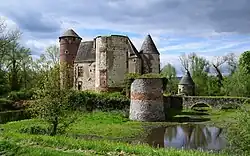 A pool in front of the castle and greenery