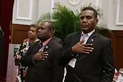 Herming (right) puts his right hand over his heart during a state dinner as part of a state visit led by Prime Minister Sogavare (26 September 2017) in Taipei, Taiwan