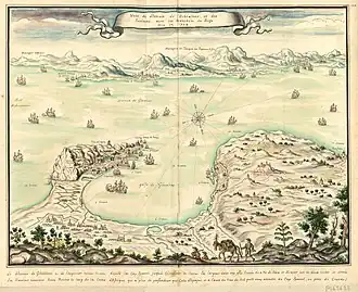 Coloured engraving of the Bay of Gibraltar as if seen from the top of a mountain to the north. Gibraltar is shown on the left, Algeciras on the right and the African coast in the background. The Spanish lines and camp are visible in the left foreground. Numerous ships are portrayed, some of them opening fire.