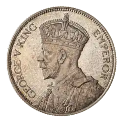 A crowned portrait of George V in royal dress, with the encircling text GEORGE V KING to the left, and EMPEROR to the right.