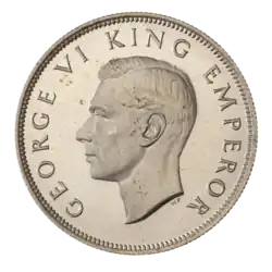 A crowned portrait of George V in royal dress, with the encircling text GEORGE V KING to the left, and EMPEROR to the right.