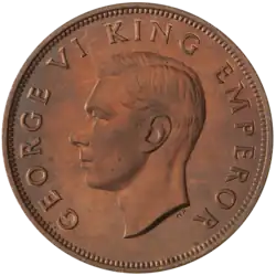 A proof penny featuring the head of King George VI circled by the text "GEORGE VI KING EMPEROR"