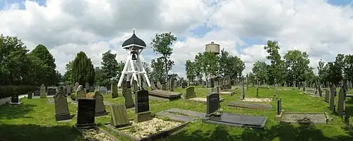 The graveyard and belfry in Nes in 2014, with in the background the Water Tower of Akkrum.