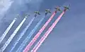 6 Sukhoi Su-25s displaying color smoke of the Russian Flag