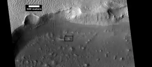 Crater wall and floor in Lycus Sulci, as seen by HiRISE under HiWish program. The crater floor contains many mounds and ridges. The part in the box is enlarged in the next photo.