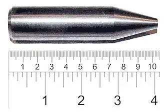 Shiny metallic cylinder with a sharpened tip. The overall length is 9&nbsp;cm and diameter about 2&nbsp;cm.