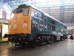 31018, at the National Railway Museum in York, on 3 June 2004. This was the first locomotive of the class to be built in 1957. It was withdrawn from service in 1976. It currently carries BR Blue livery. Note the absence of over-window head code panel, which were only omitted from the first few locomotives.