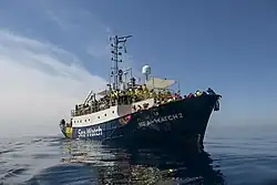 Sea-Watch 2 crowded with survivors who cover themselves in rescue blankets on 19 March 2017