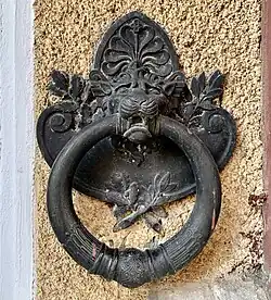 Greek Revival cartouche of a horse tie ring of the Adina and Emil Costinescu House (Strada Polonă no. 4), Bucharest, by Ion D. Berindey, 1911-1915[21]