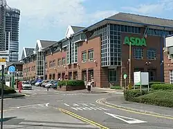 Asda's Headquarters, Asda House in Leeds; Asda was the UK's second largest supermarket until 2014, and is now third; Asda turned over £23.3&nbsp;billion in 2015, and is the region's largest company
