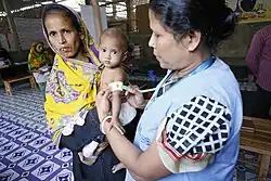 Image depicting a young child being assessed for severe malnutrition