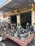 A thathera selling utensils in Thathera market.