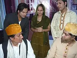 Four men and a smiling woman