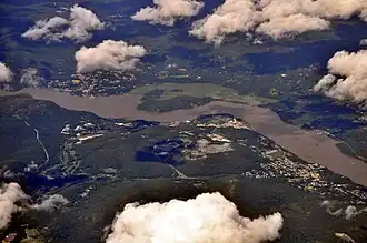 Aerial view from southwest includes the Hudson River, Highland Falls (on right), Cold Spring (on left) across the river in Putnam&nbsp;County