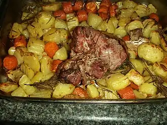 Cooked boneless leg of lamb with potatoes and carrots, Italy
