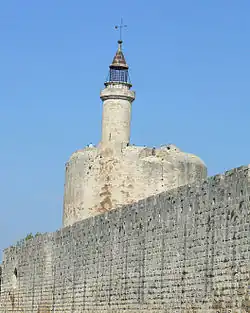 Putlog holes for hoardings are visible running along the top of the wall at Aigues-Mortes, France.