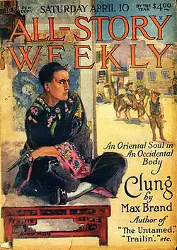 A man holding a gun and wearing a robe sits and watches cowboys in the street