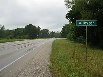 Alleyton road sign on FM 102 looking north