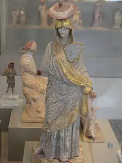 Terracota figurine of a woman with painted blue and gilt garment, from Tanagra, 325–300 BC, Antikensammlung Berlin, Germany