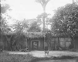 An Igbo compound entrance, in or near Önïcha. Photographed by Herbert Wimberley, c. 1903–18. Cambridge University