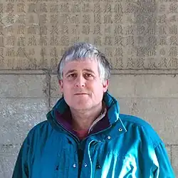 Andrew West at the Cloud Platform at Juyongguan, in front of a Tangut Buddhist inscription, December 2013
