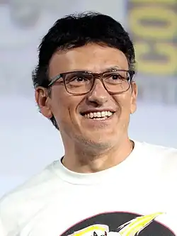 A photograph of a man with glasses, smiling offscreen.