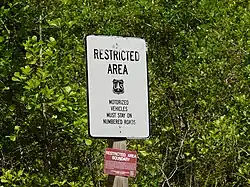 Sign warning vehicles to remain on numbered forest roads