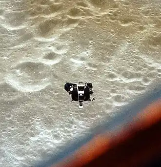 A Lunar Module with the moon in the background as it approaches the Command and Service Module for redocking
