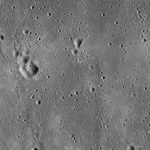 Lunar Orbiter 5 image from 1967, cropped to show the vicinity of the landing site of Apollo 11, used in mission planning. The image is centered precisely on a small crater called West crater (190 m in diameter), and the Lunar Module Eagle touched down about 550 m west of West Crater. The area shown is approximately 25&nbsp;km × 25&nbsp;km across.