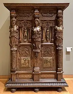 Henry II style wardrobe; c. 1580; walnut and oak, partially gilded and painted; height: 2.06 m, width: 1.50 m, depth: 0.60 m[104]