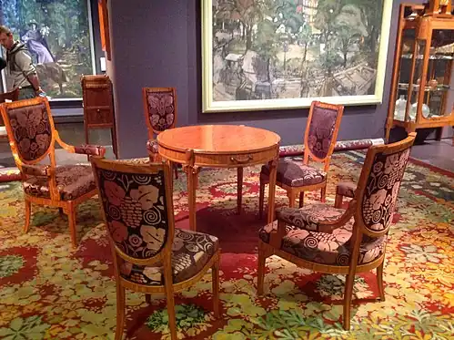 Table and chairs by Maurice Dufrêne and carpet by Paul Follot at the 1912 Salon des artistes décorateurs