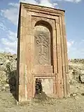 Huge khachkar monument behind Artavazik Church of the 13th century