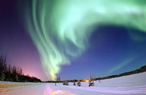 The aurora borealis, or northern lights, above Bear Lake, Alaska
