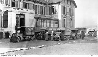 Ambulances outside the Australian Voluntary Hospital at the Hôtel du Golf et Cosmopolite in Wimereux. The ambulances carry signs indicating their donors, such as the "Red Cross Society, Queensland"