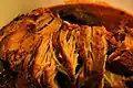Cochinita Pibil, a fire pit-smoked pork dish, seasoned with achiote, spices and Seville orange
