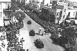 British armoured vehicles parading through Allenby Street in Tel Aviv, in honor of the Silver Jubilee of King George V in 1935