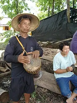 Medium Klong yao hand-drum, player in Laos