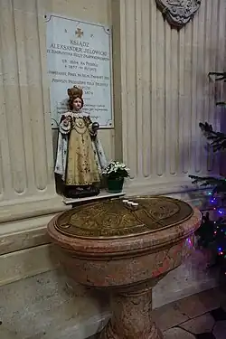 The Baptismal font, with porcelain statue of the Infant Jesus.