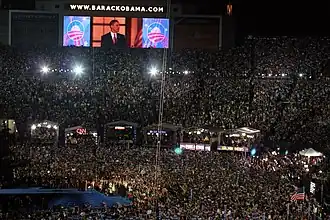 (C) The above-described four-teleprompter set-up in use at the 2008 Democratic National Convention in Denver, Colorado, USA (The large confidence monitor under the TV cameras is near the bottom far right of this frame.)