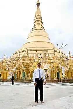 Image 12Former US President Barack Obama poses barefoot on the grounds of Shwedagon Pagoda, one of Myanmar's major Buddhist pilgrimage sites. (from Culture of Myanmar)