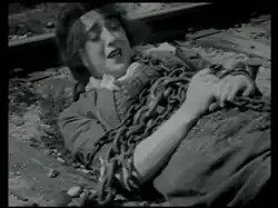 Mabel chained to the tracks