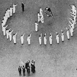 Bellamy salutes in 1917 at a Fifth Avenue ceremony opposite the Union League Club reviewing stand during the "Wake Up, America!" celebration, where thousands marched in the procession