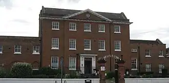 Georgian red-brick 3-storey mansion house with neoclassical pediment
