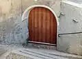 Old wooden door of a House on Plaz in Vnà.