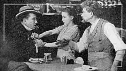Black and white film still showing a woman serving in a diner