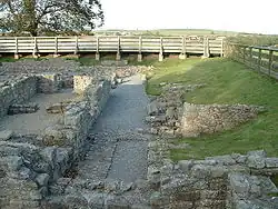The ruins of a building. The remains of stone walls up to about 1-foot (0.30 m) are all that remains.