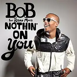 A picture of B.o.B standing up on the left of the image while laughing, with the words "B.o.B feat. Bruno Mars Nothin' on You" with capital font on the right of B.o.B