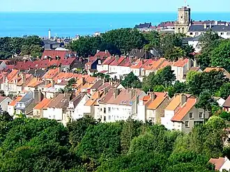 A general view from the Brecquerecque Quarter: The modern lighthouse, the medieval bell tower and the English Channel