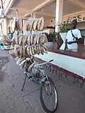 Distributing bread by bicycle near Lake Tanganyika in the Democratic Republic of the Congo